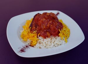 Eggplant & Young Grape Stew (Ghoore Bademjun)
Slow-cooked eggplant, tomato, onion & ghooreh (young sour grapes), saffron topped rice.

 at Noush in Barcelona