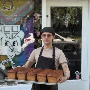 Owner with home-made bread  at Kostki in Warsaw