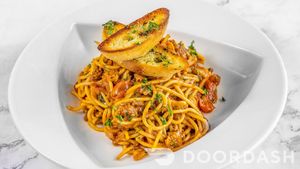 SPAGETHI BOLOGNESE/Plant based ground meat sauce, fresh tomatoes, Italian herbs and our signature garlic crouton. (Gluten-Free Pasta Available) at Vegan Tierra  in North Miami