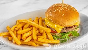 TIERRA BURGER/ American cheese, arugula, tomatoes, onions, sesame seeds bun. Served with fries. at Vegan Tierra  in North Miami