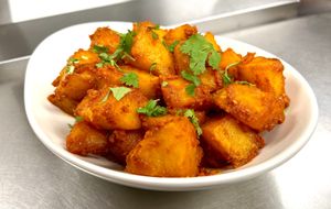 Flavorful Bombay Aloo with tender potatoes sautéed in aromatic spices and herbs. A vibrant vegan dish perfect for a comforting and zesty meal. 🌱🥔 at India Express in Denver