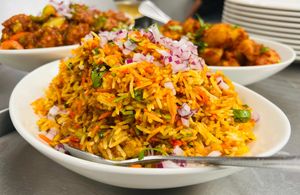 Fragrant Vegetable Biryani with basmati rice, garden-fresh vegetables, and traditional Indian spices. A colorful, flavorful vegan dish perfect for a satisfying and aromatic meal.  at India Express in Denver