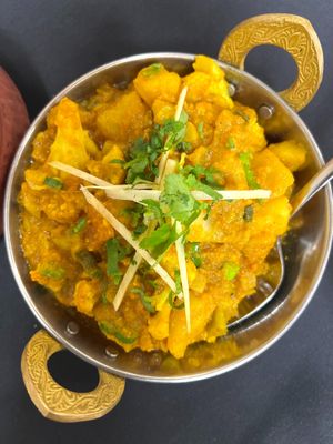 Savory Aloo Gobi with tender potatoes and cauliflower cooked in fragrant spices and herbs. A classic vegan dish enjoyed by plant-based food lovers. 🌱🥘 at India Express in Denver