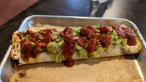 Cauliflower chorizo burrito with no cheese, rice, beans, added guac, pickled red onions, and hot sauce!  at Fuego Tacos & Mezcal in Winchester