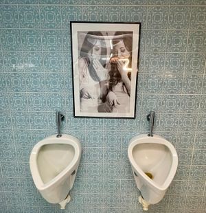The men's toilet with a touch of humor on the walls at Hotel Nicolay in Zeltingen-rachtig