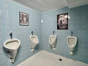 The men's toilet with a touch of humor on the walls at Hotel Nicolay in Zeltingen-rachtig