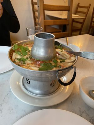 Tom kha soup. You can’t see it in the photo, but there’s a gentle flame shooting up the center to keep the soup warm    at Araya's Place - Madison St in Seattle