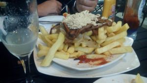 Vegan chorrillana - with seitan, scrambled tofu, caramelised onions and loads of chips. 

Note the pisco sour on the side :) at Soju in Santiago