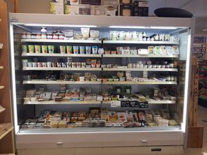 Refrigerated section at La Pomme d'Api by Kiss the Ground in Monthey