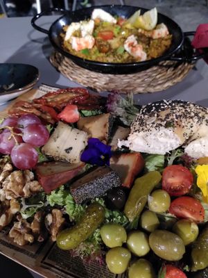 Tres amigos cheese platter and shrimp paella at Bubita Bar in Barcelona