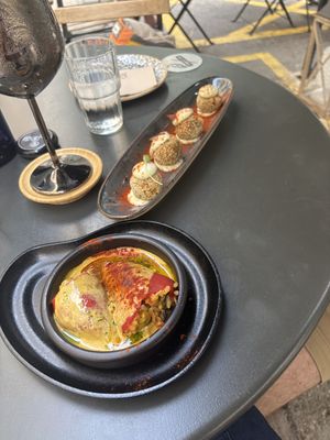 Stuffed peppers with hollandaise sauce and croquetas in the backgroundd  at Bubita Bar in Barcelona