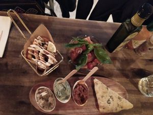 Fried calamari, mini tomato salad with basil leaves and dips. at Bubita Bar in Barcelona