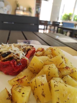 Red bell pepper filled with rice and potatoes on the side at Veganda in Padua