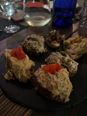 The two crostini in front featured bland hummus, the one in the far left corner with the seitan was good, the rest tasted like straight mayonnaise    at Veganda in Padua