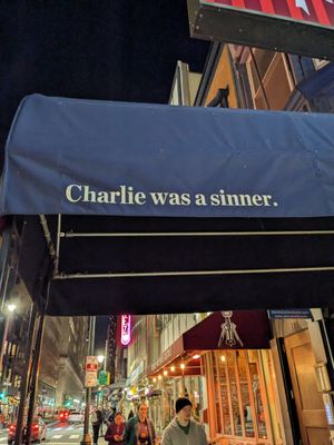 Sign outside at Charlie Was a Sinner in Philadelphia
