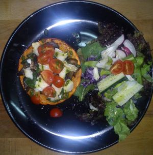 Daily Special main course, Pumpkin stuffed with mushrooms, kale & goats cheese with side salad at Chirimoya Healthy Food Station in Fuengirola