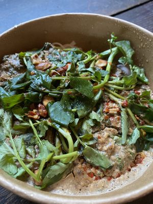 Rice Noodle w/almond hazelnut sauce, charred chili, greens. Very unique and yummy  at Harvest Community Foods in Vancouver