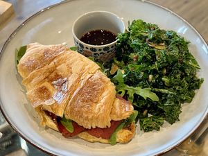 Vegan croissant with pastrami and homemade ricotta with a kale side   at Detox Lounge in Inverness