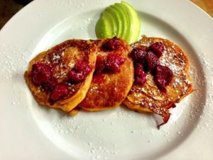 Sweet potato pancakes, served with seasonal fruit.
Gluten free.
The bottom gets caramelised, which makes it really yummy.
Lightly sweet and savoury at the same time. 
And quite greasy.  at Yuli's Lunch Box in Haifa