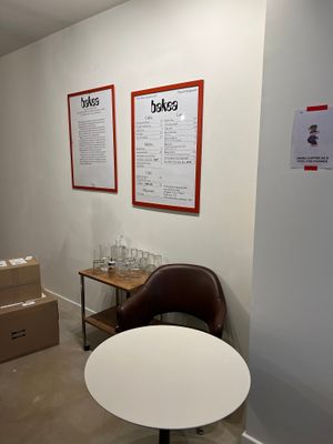 Cardápio e quadro explicando a missão de causar impacto positivo por meio do prazer do café at Bakea in Paris