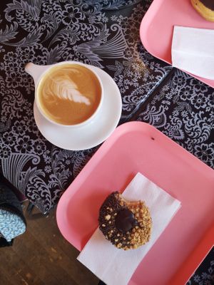 Chocolate Peanutbutter donut with coffee at Glam Doll Donuts - Eat Street in Minneapolis