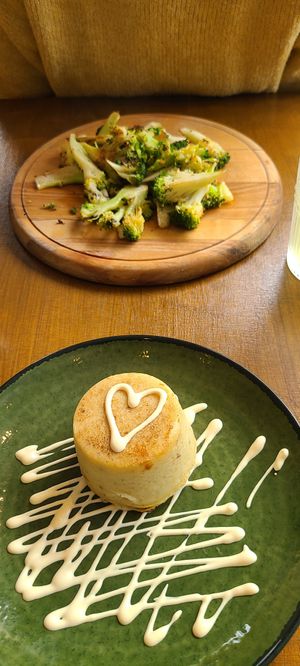 Sauted broccoli with garlic and chili, cauliflower flan with vegan hollandaise sauce. at Vegitalian in Salzburg