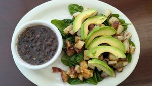 Side of black beans(they don't use meat broth or lard!), raw spinach, home fries, and avocado. at Food Bash in Winchester