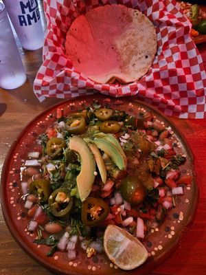Handmade tortillas under pintos Salsa Fresca and avocado. I love it. at Mas Amor in Chico