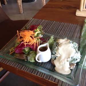 Corn bread w/ chive cashew feta, garlic roast tomato spinach hollondaise at Divine Earth in Seminyak