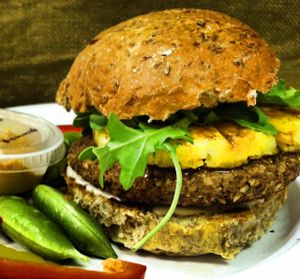 Handcrafted vegan burgers. The Islander patty is made with mushroom, fresh ginger, garlic, cabbage and Iss' Magic Oatmeal Mix. Served on a sprouted grain bun with grilled pineapple,soyaki sauce and arugula & a side of raw veggies and red pepper hummu at Iss' Magic Mixes Oatmeal Cafe in Mesa