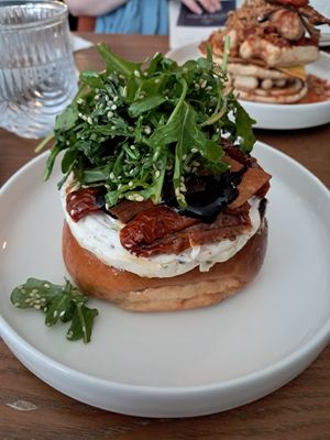 Bun with dill cream cheese, sundried tomatoes  bacon and balsamic reduction at BIG Sister in London