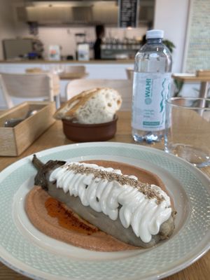 roasted eggplant, gojju cream (tomato and spices), mint and coriander chutney, vegan sauce, sesame seeds  at June Collective in Lombardia