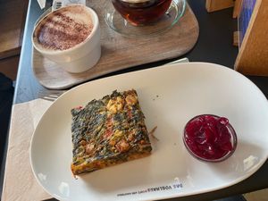 Quiche with spinach and vegan feta, onion chutney and mocchaccino with oat milk  at Das Voglhaus in Konstanz
