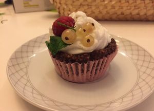 Raw vegan cupcake with cream and raspberries on top at Zielony Talerzyk in Lublin