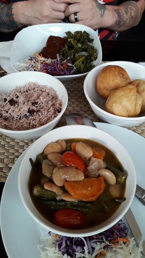 Okra and butter beans.   Jerk tofu and spicy kale .. fried dumplings.. peas and rice  washed down with apple and beetroot juice at Fi Real in Bristol