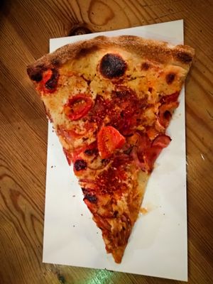 A slice of vegan pizza at Hatool HaYarok - The Green Cat at Hatool HaYarok - The Green Cat in Tel Aviv