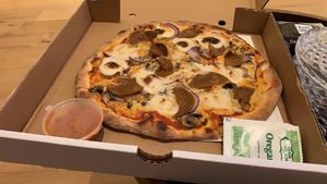 Mushroom, red onion, pepperoni and mozzarella personal pizza!  at Hatool HaYarok - The Green Cat in Tel Aviv