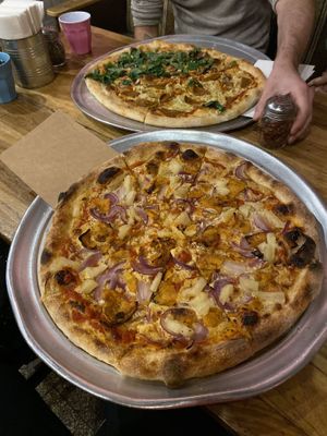 Pizza vegan pineapple and red onion and a large pizza with herbs, vegan salami and mushrooms  at Hatool HaYarok - The Green Cat in Tel Aviv
