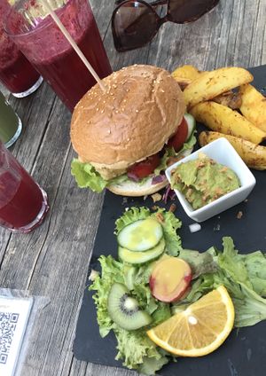 Crispy tofu burger with potato wedges and avocado dip at Moehren Milieu Eco Cafe in Mainz
