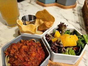 Combo meal with pasta Bolognese, green salad with mango, and spring rolls at OVOCafe - Wan Chai Rd in Hong Kong Island