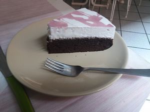 Vegan chocolate cake with cream at Alhambra Cafe in Milan