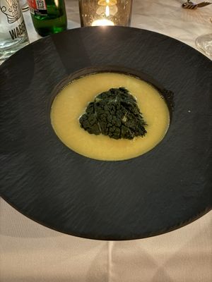 Creamy broth with a cavalo nero package filled with marinated jackfruit   at Waber. in Overijssel
