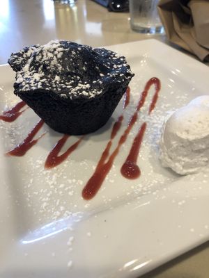 Chocolate vegan cake with raspberry coulis and whipped coconut cream. at Bravo in Jackson