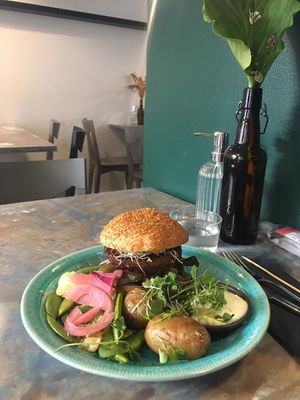 Pulled oats burger with baked potatoes, mayonnaise and vegetables at OmNam in Helsinki