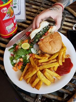 Spinach burger. It had so much spinach! I would recommend this for anyone (including vegans) with a burger craving. at Pumpernicle German Bakery in Rishikesh