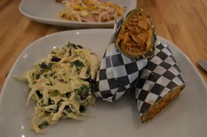 This week's special...Pulled BBQ jackfruit wrap. Pulled vegan jackfruit "pork" in housemade hickory BBQ sauce wrapped in a warm tortilla w/ cabbage slaw, pickle, and chipotle mayo, served w/ a cranberry tahini slaw. SO good. at Yam Chops in Toronto