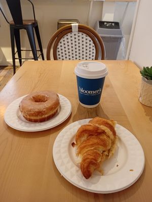 Cheese and tomato croissant and glazed doughnut with a hot chocolate. at bloomer's in Toronto
