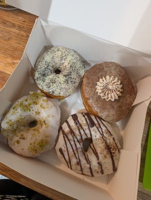 Box of 4 donuts: lemon poppy, chai, rose pistachio, salted caramel at bloomer's in Toronto