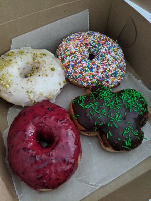 Rose pistachio, vanilla sprinkle, blueberry and a holiday feature filled donut at bloomer's in Toronto