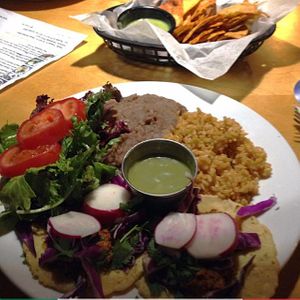 Taco Thursday plate with chips and salsa in the background at Flacos in Fresno